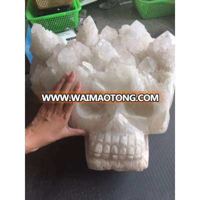 Natural hand carved clear quartz crystal skull with cluster on the head for crafts